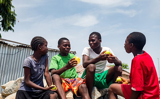 children playing and eating fruit children playing and eating fruit